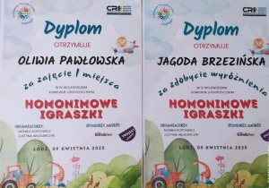 Dyplom za zajęcie I miescja dla Oliwii Pawłowskiej w konkursie plastycznym "Homonimowe Igraszki" oraz wyróżnienie dla Jagody Brzeźińskiej.
